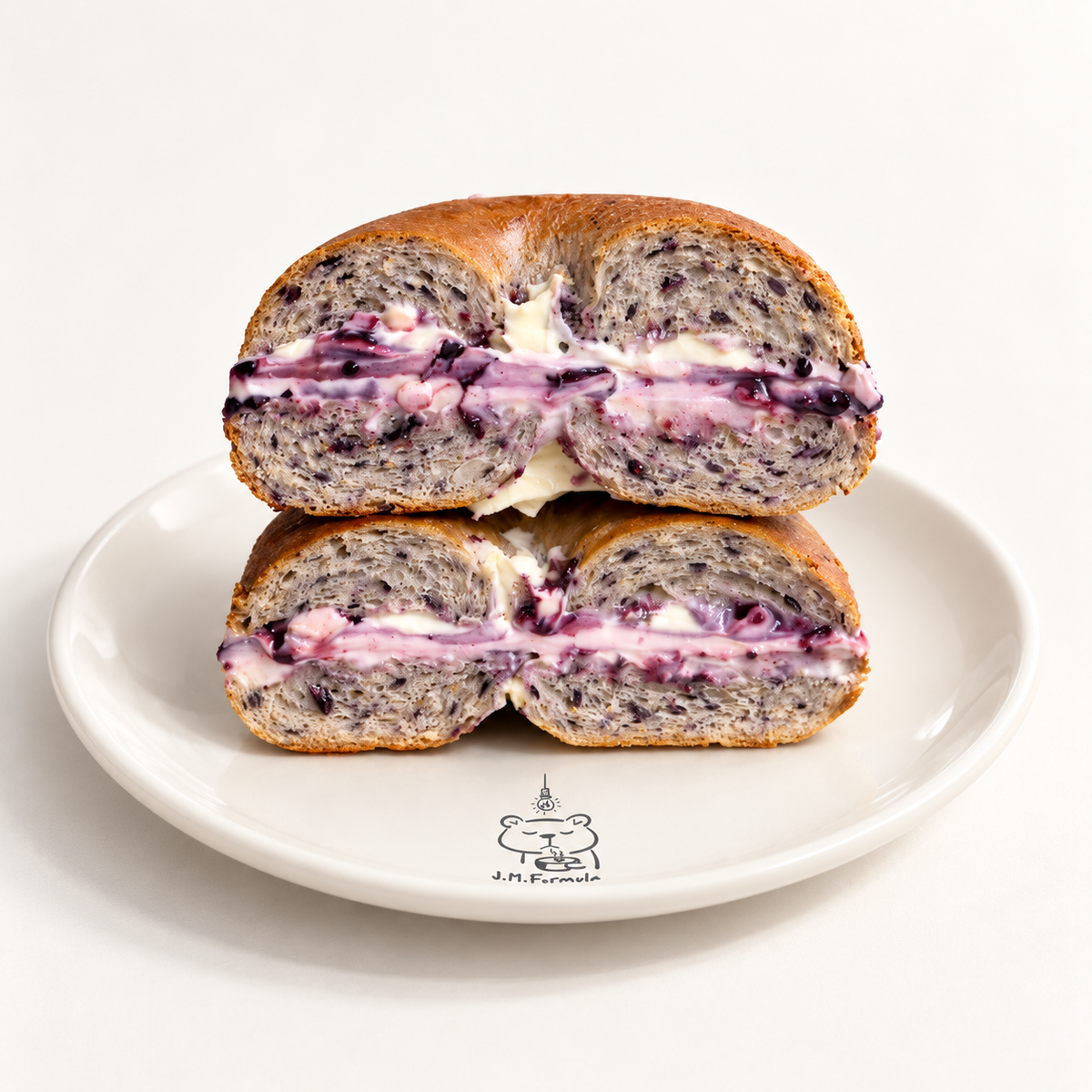 JM Formula Blueberry Bagel with Blueberry Cream Cheese with subtle JM Formula branding on an off-white background