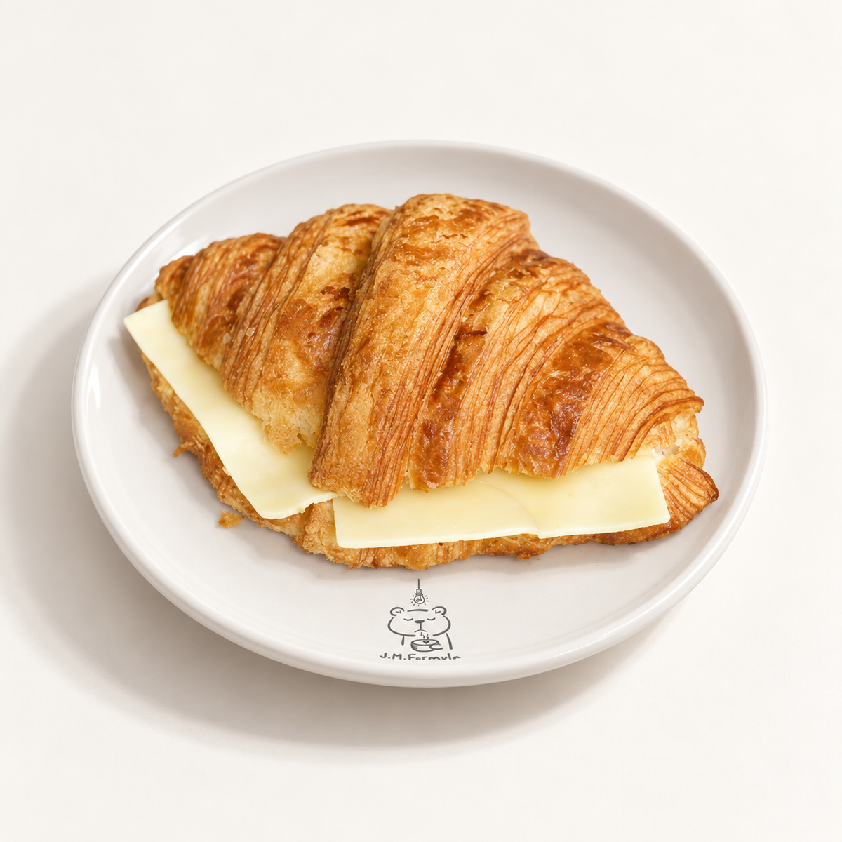 JM Formula Cheese Croissant on an off-white background