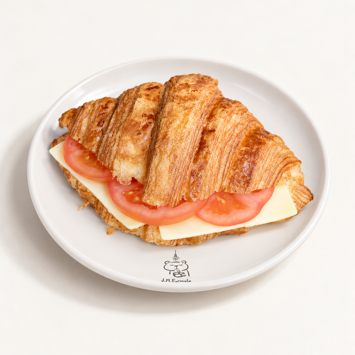 JM Formula Cheese & Tomato Croissant on an off-white background