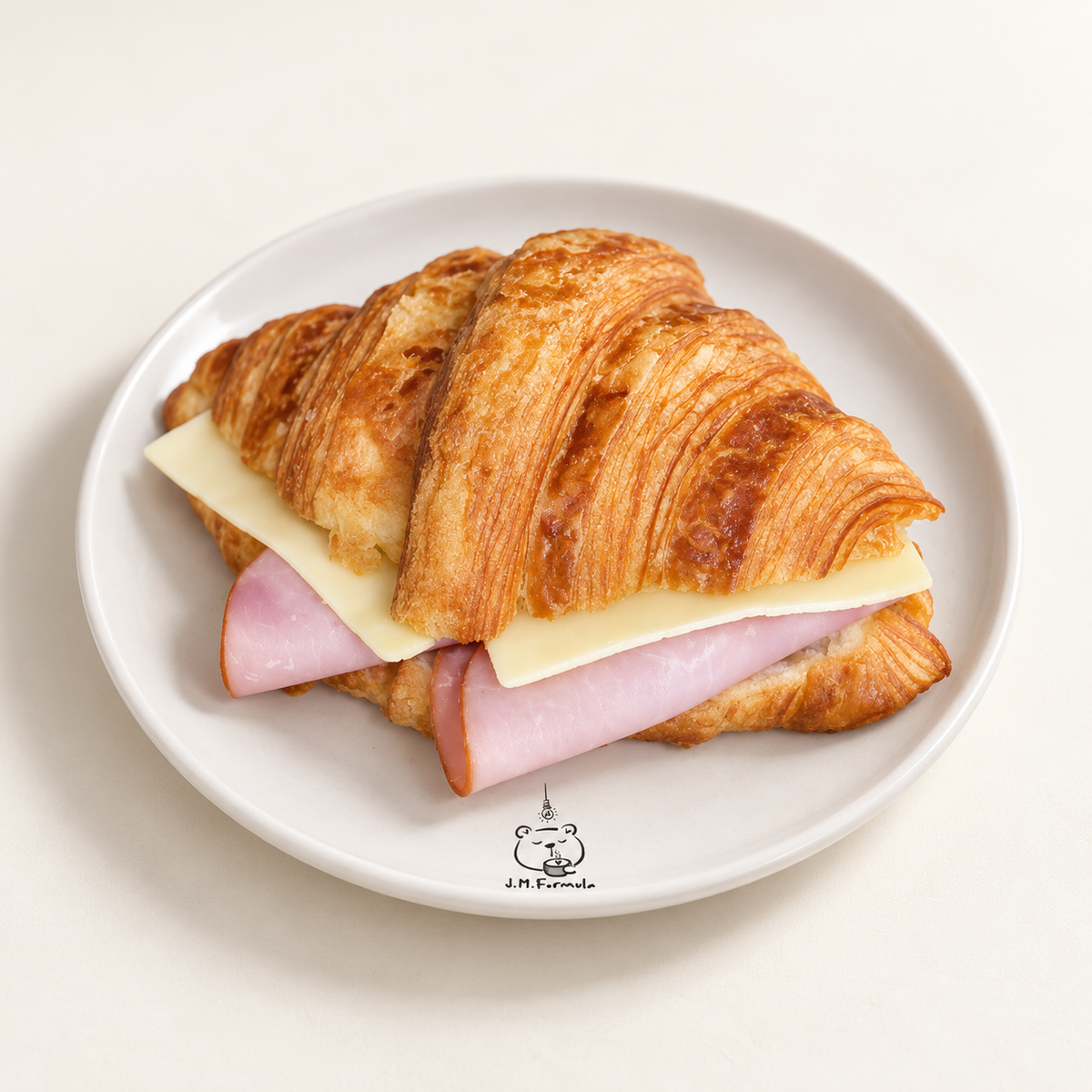 JM Formula Ham & Cheese Croissant on an off-white background