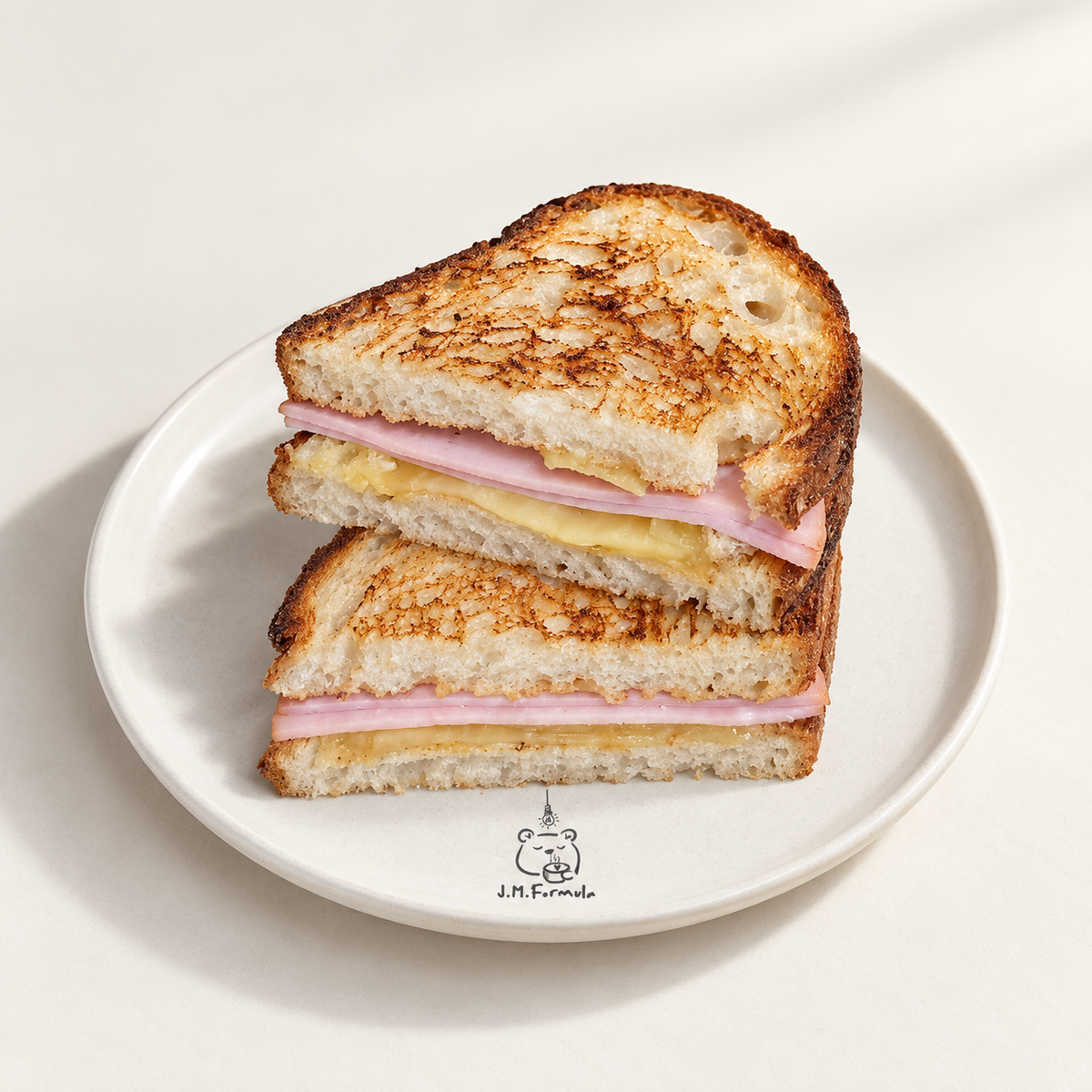JM Formula Ham & Cheese Toastie on an off-white background